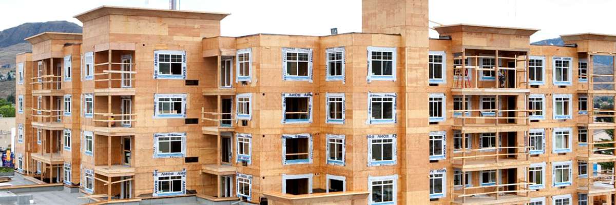 Modern office building interior with open workspace and natural light, representing commercial building design.
