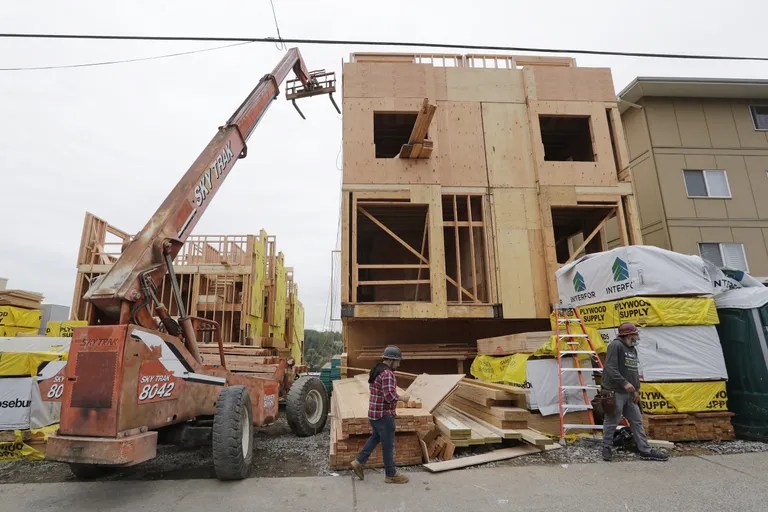 Construction worker in hard hat and face mask, depicting safety measures during the pandemic.